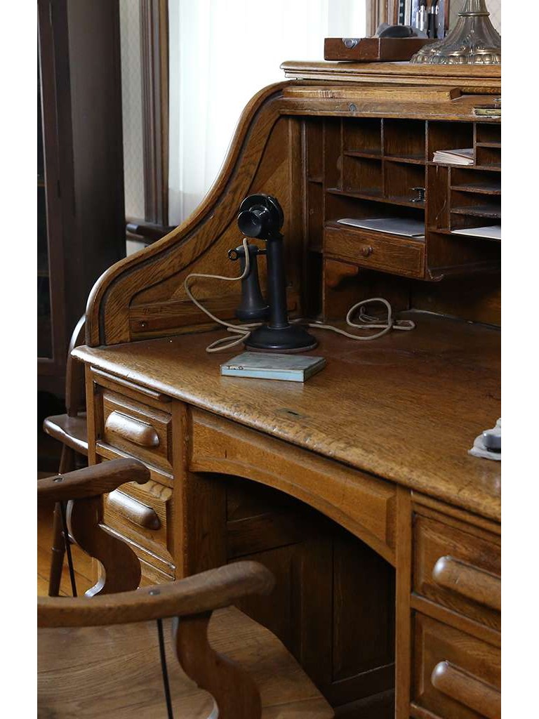 Antique wooden desk with candlestick telephone
