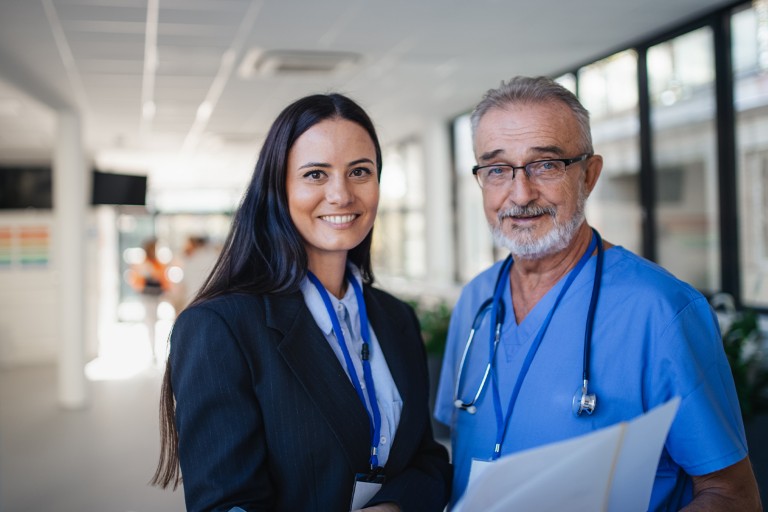 A doctor and a business woman in the corridor of a healthcare facility