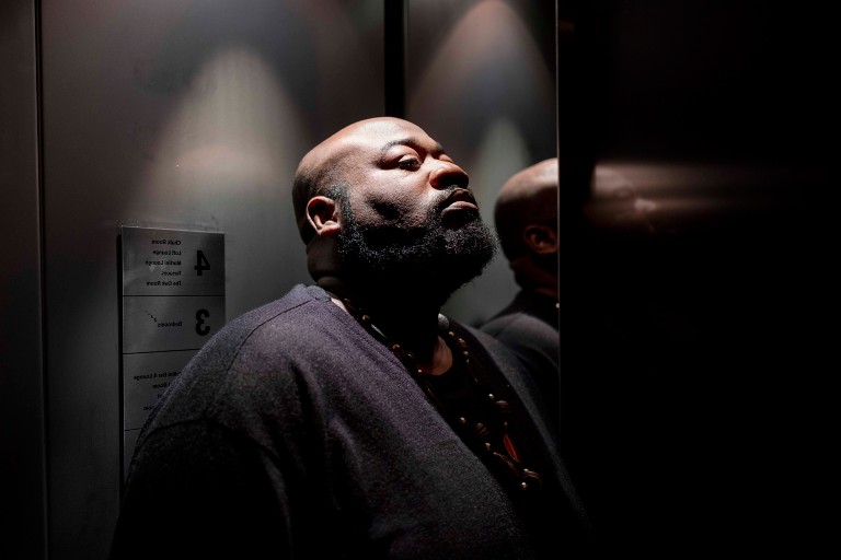 A person stands in a dimly lit elevator