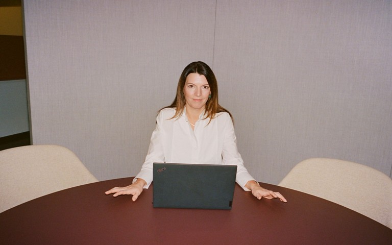 Cristina sitting in front of the laptop