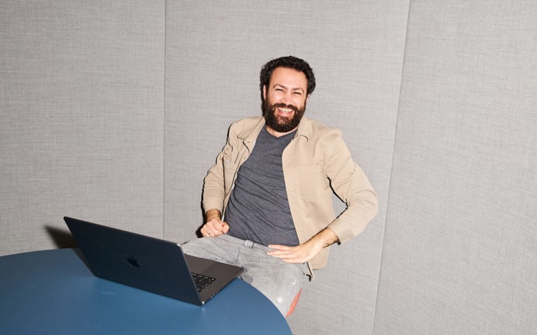 Asaf sitting in front of the laptop