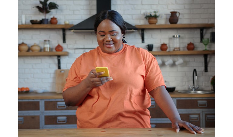 An obese woman scrolls through her phone to find a doctor