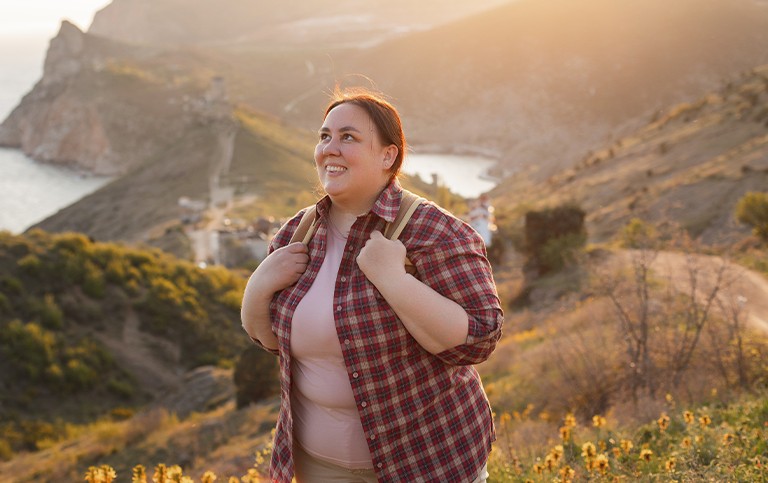 A woman with a backpack on a scenic hike