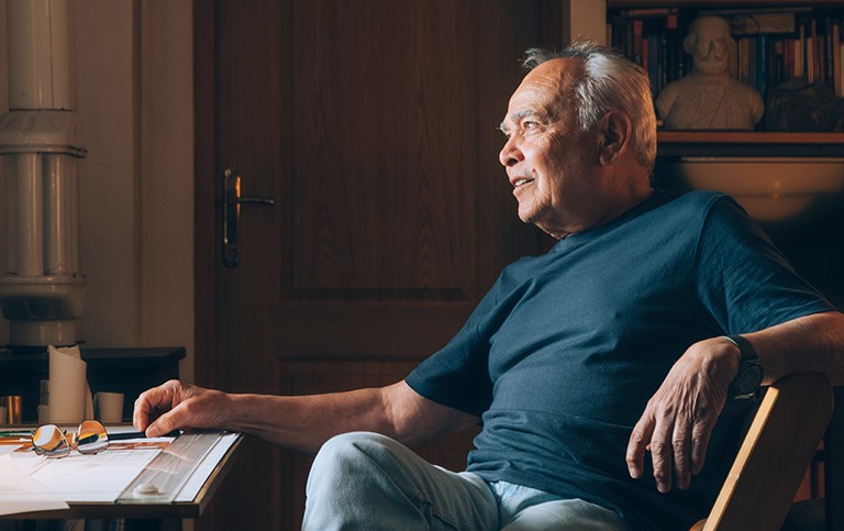 A senior man sitting at his desk