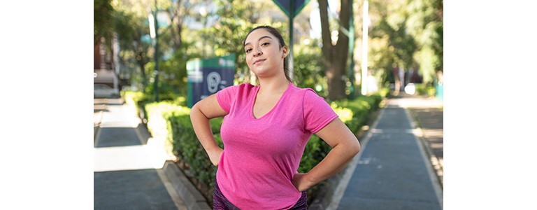 Woman standing proudly with her hands on her hips