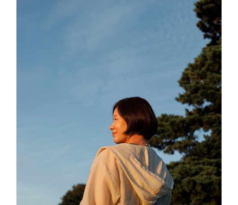 Woman in the sun under a clear blue sky