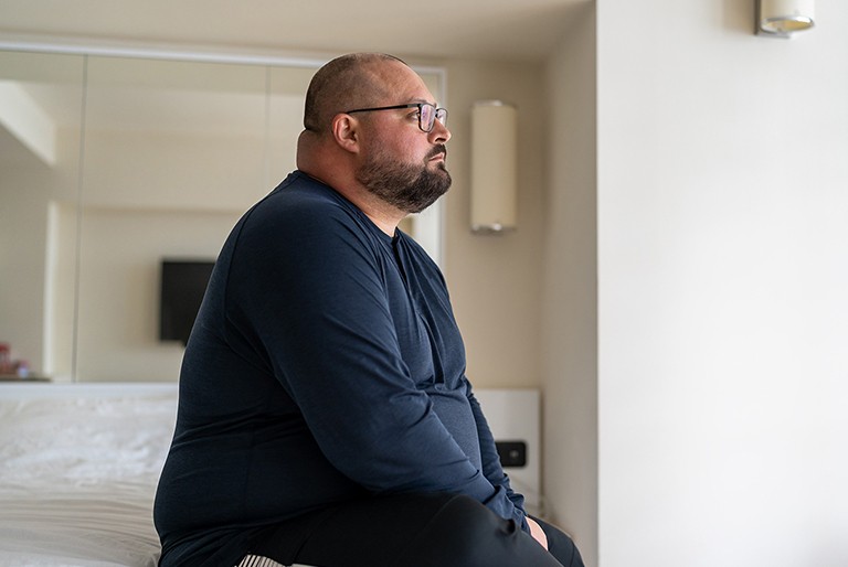 Man staring pensively out a window