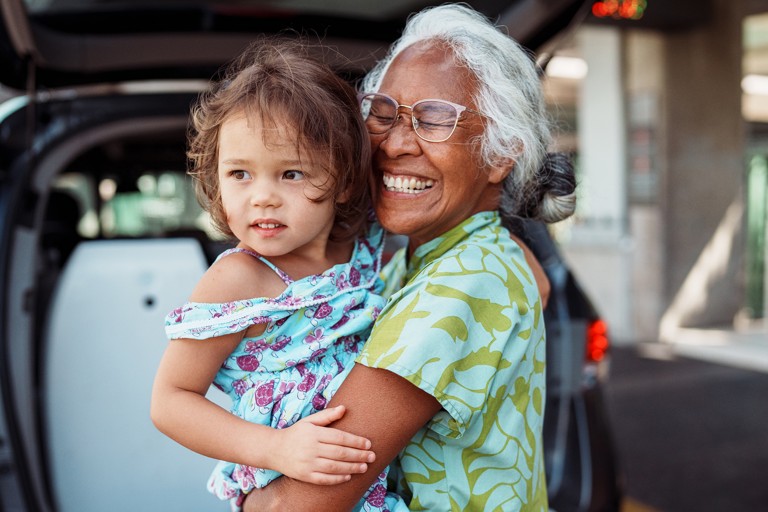 A happy elderly woman with a small child 