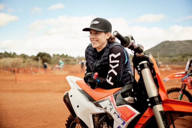 image of womand next to a motorcycle