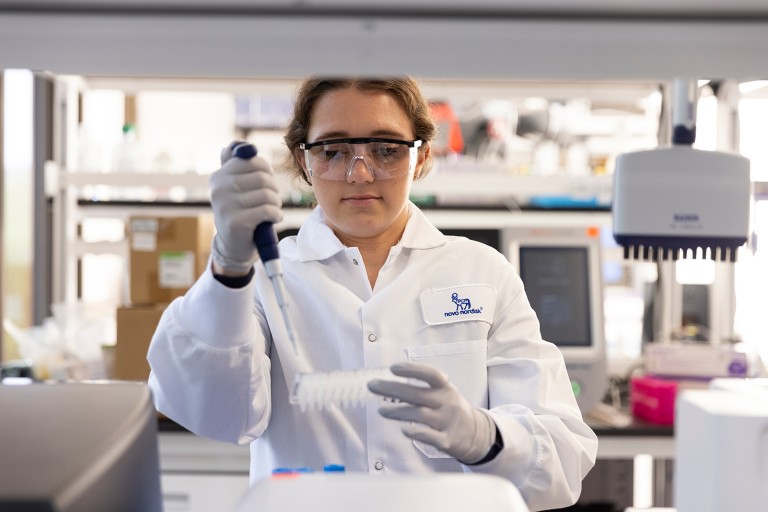 A Novo Nordisk employee working in a lab setting