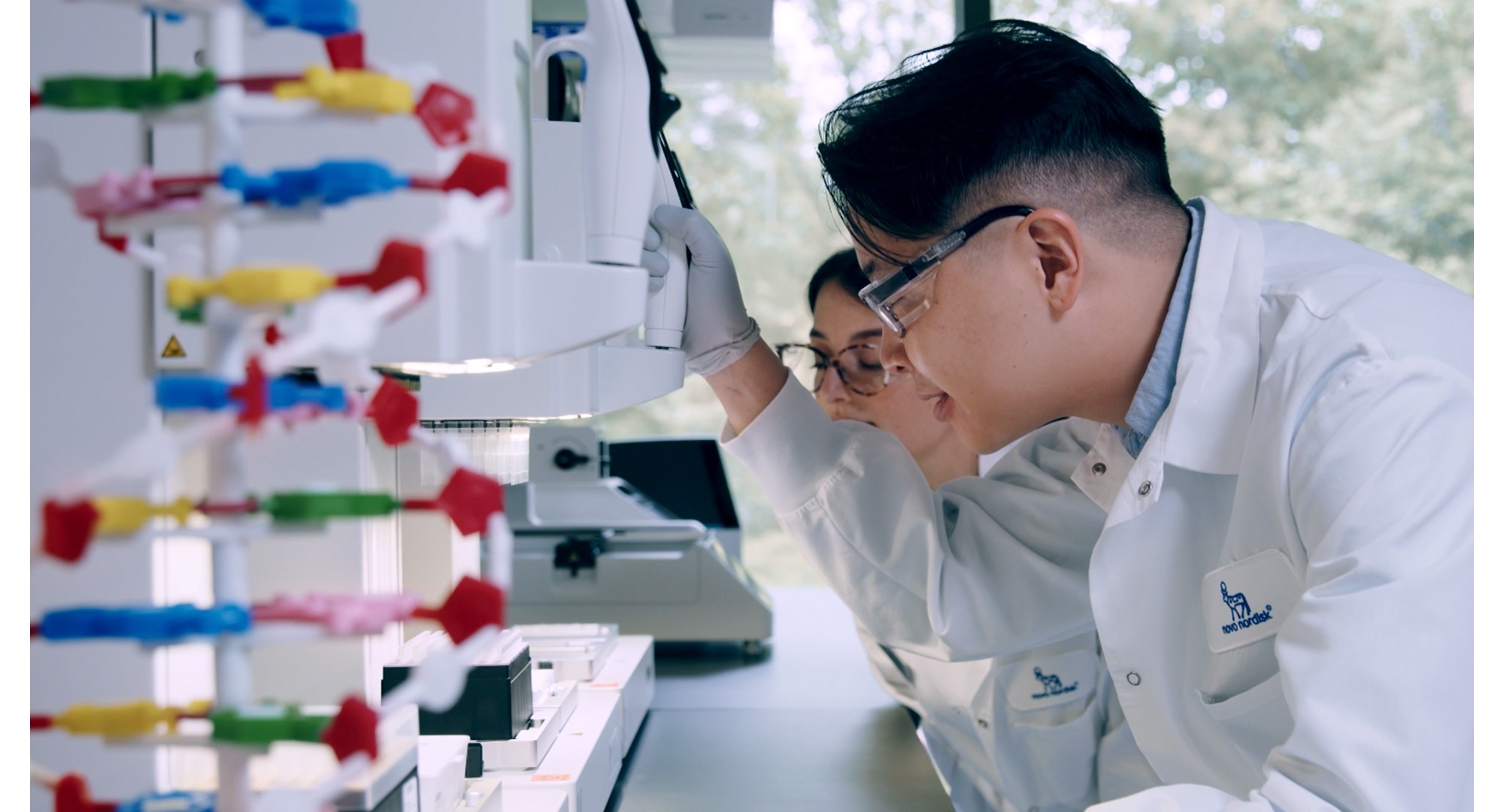 Gene and his colleague conducting research together in the lab.