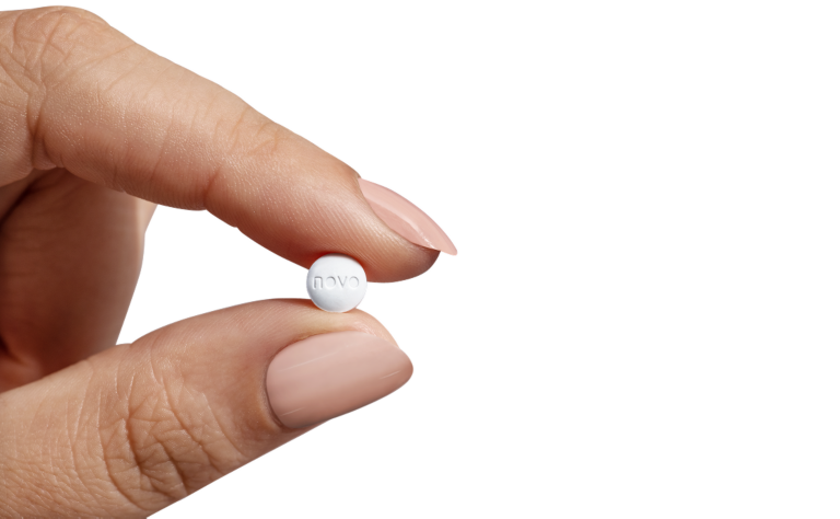 Image of hand holding Wegovy® Pill