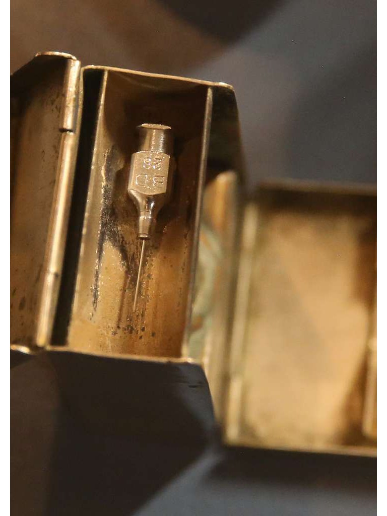 Antique needle encased in a metal container