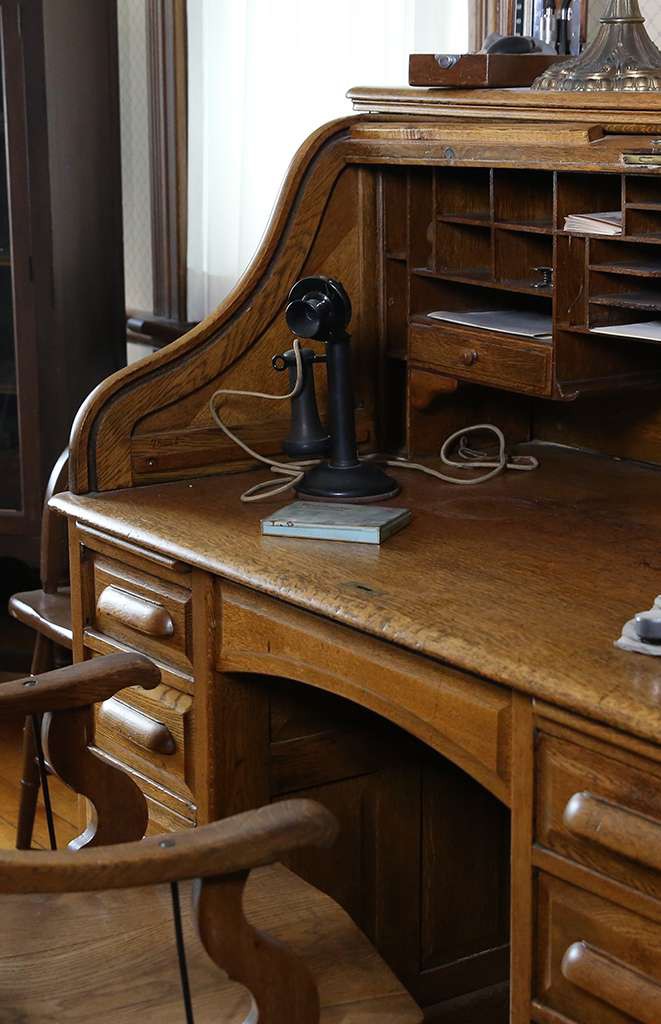 Antique wooden desk with candlestick telephone