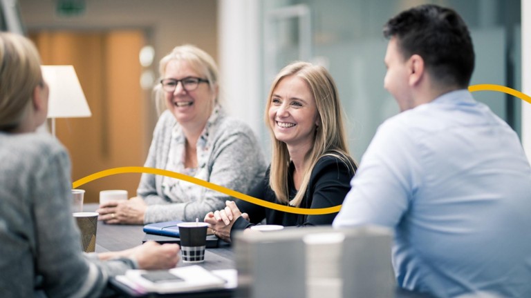 Group of work colleagues chatting and laughing