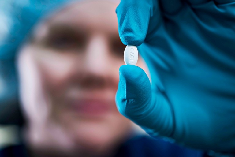 Novo Nordisk colleague holding a pill