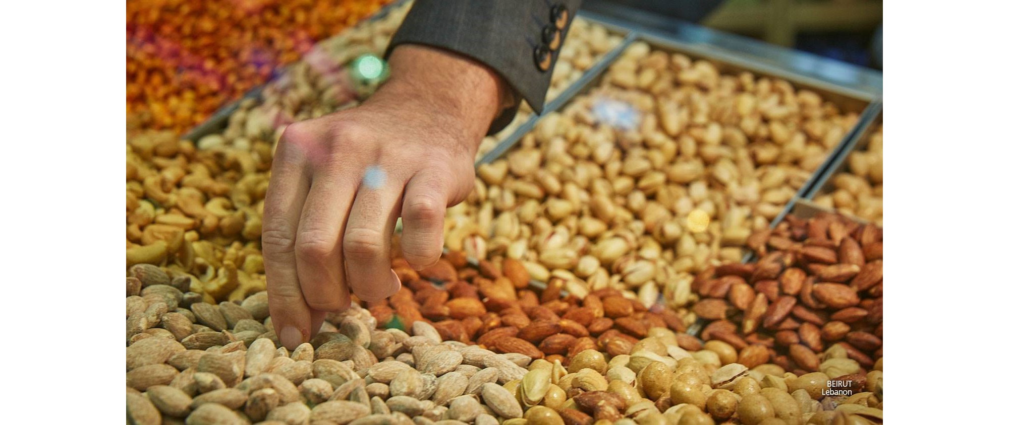 Hand taking almonds at the market