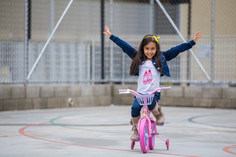 Suellen Luisa Andrade on her pink bike
