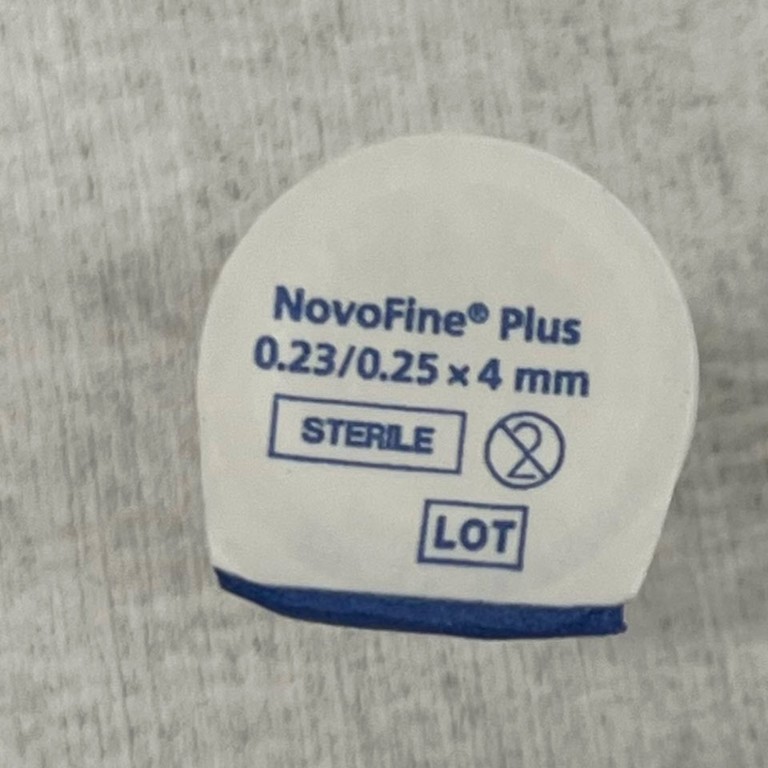 Image showing a top view of an authentic Ozempic® Needle. The paper tab states ‘NovoFine® Plus’ as well as ‘0.23/0.25 x 4 mm’]