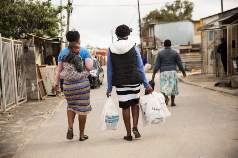 Women walking with carrying grocery bags