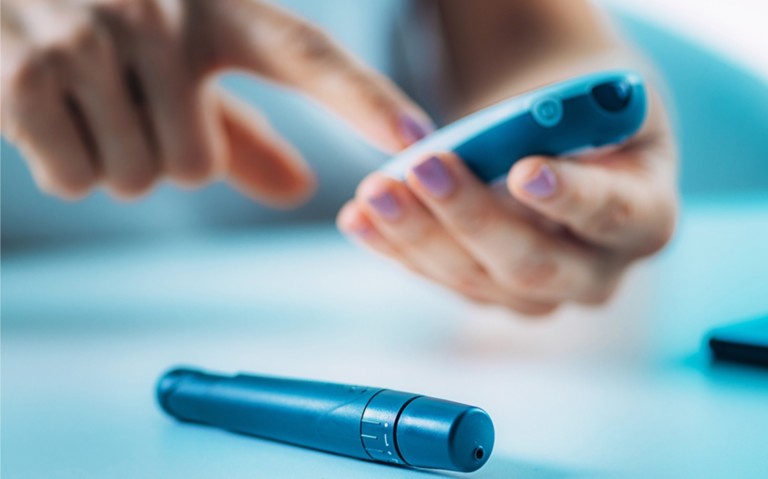 Image of a hand and an insulin pen device