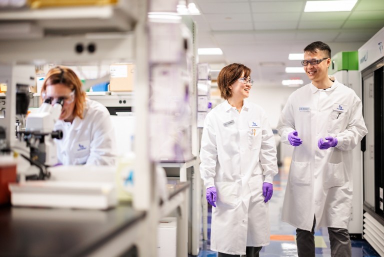 Photo of three researchers in a lab environment