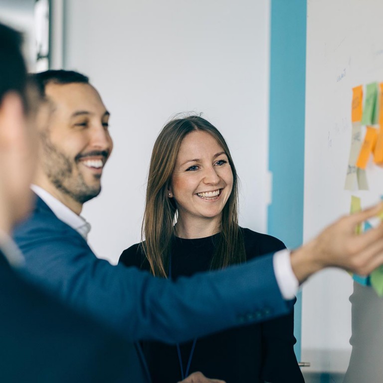 Three employees discussing with each other