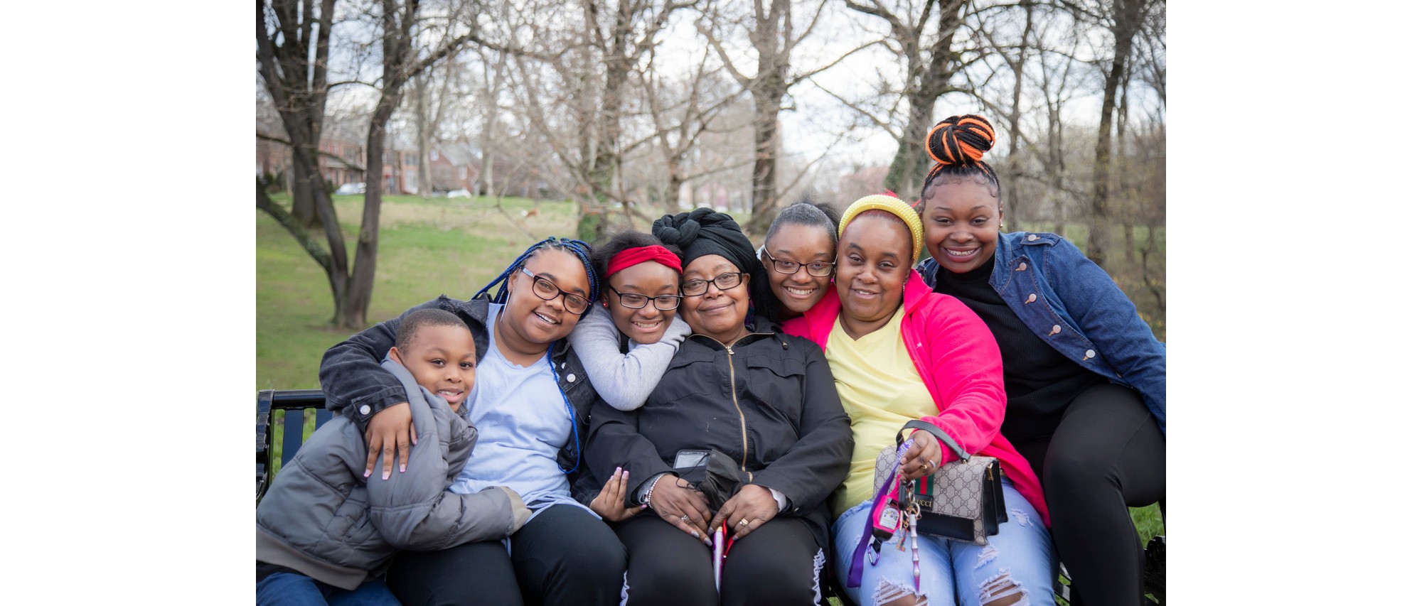 Sheenia and her family all squeezed onto a bench in the local park